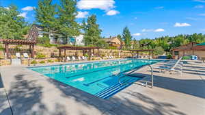 View of swimming pool with a pergola and a patio area