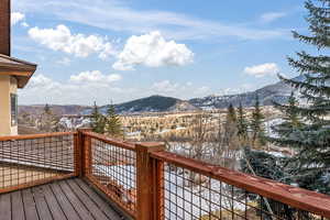 Snow covered deck featuring a mountain view