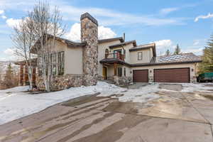 View of front of house with a balcony and a garage