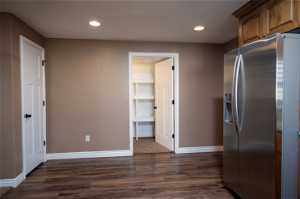 Kitchen with stainless steel fridge and dark hardwood / wood-style flooring