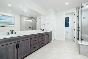 Bathroom featuring vanity and a shower with door