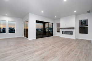 Unfurnished living room with light wood-type flooring