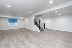 Basement with light wood-type flooring