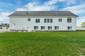 Rear view of property featuring a lawn