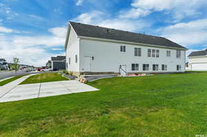 Rear view of house with a yard