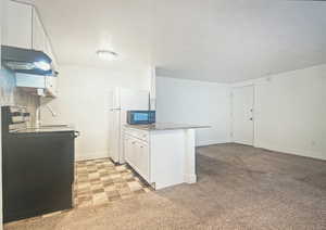 Kitchen with tile floors and tasteful backsplash