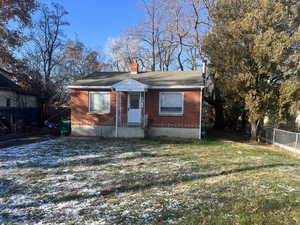 Bungalow-style home with a front yard