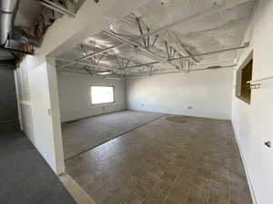 Basement with dark tile flooring