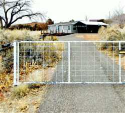 Gated driveway to house and acreage.