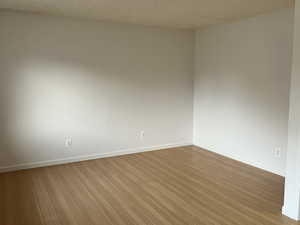 Empty room with light hardwood / wood-style floors