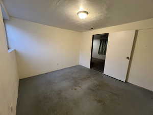 Basement bedroom with a textured ceiling