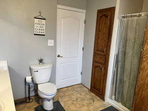 Bathroom featuring toilet, storage and vanity