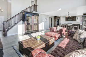 Living room featuring an inviting chandelier and hardwood / wood-style floors