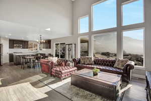 Living room featuring, a towering ceiling, and light hardwood / wood-style floors