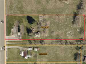 Ariel view of the property. 1.48 acres. Pasture for animals. Covered patio. Fire pit. Dog run. Outbuildings. RV parking.