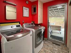 Spacious main floor laundry room with door to back patio