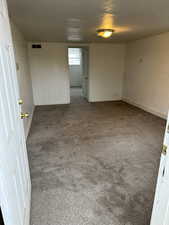 Spare room with dark carpet