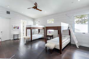 Bedroom with multiple windows, hardwood / wood-style flooring, vaulted ceiling, ceiling fan, and recessed lighting