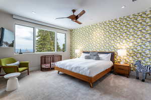 Carpeted bedroom with an accent wall, wallpapered walls, and baseboards
