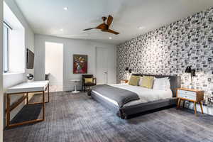 Carpeted bedroom featuring recessed lighting and a ceiling fan