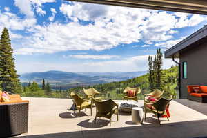 View of patio featuring a mountain view and an outdoor fire pit