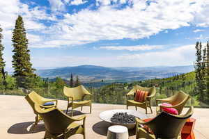 View of patio featuring a fire pit and a mountain view