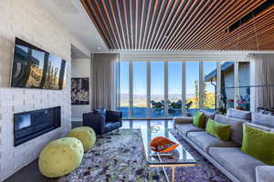 Living room featuring a brick fireplace and healthy amount of natural light