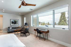 Living area with light colored carpet, ceiling fan, baseboards, and recessed lighting