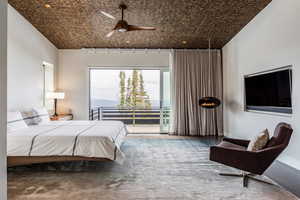 Bedroom with access to exterior, ceiling fan, and carpet flooring