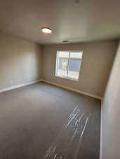 View of carpeted spare room