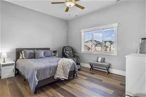 Bedroom featuring En-suite bathroom, dark hardwood / wood-style flooring and ceiling fan