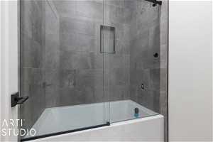 Bathroom with combined bath / shower with glass door