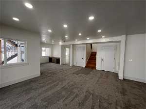Unfurnished living room with dark carpet
