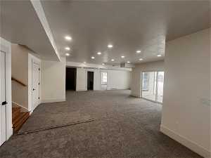 Interior space featuring dark colored carpet