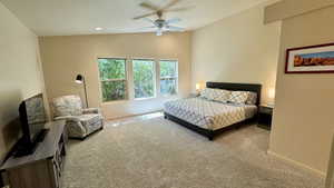 Bedroom featuring carpet flooring, lofted ceiling, and ceiling fan