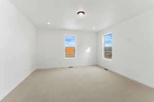 Empty room with light colored carpet