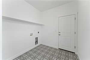 Washroom featuring electric dryer hookup, light tile flooring, and washer hookup