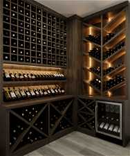 Wine room with wine cooler and hardwood / wood-style flooring