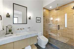 Bathroom featuring toilet, vanity, an enclosed shower, and tile flooring