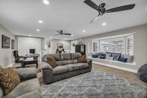 Large coat closet, TWO minimalist ceiling fans, recessed lighting, and a bay window.