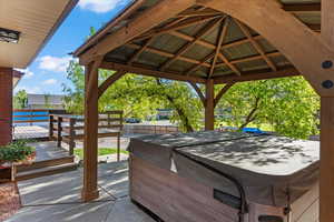 View of terrace featuring a gazebo and a hot tub