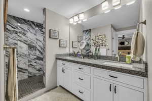 Master bathroom with double vanity and tiled shower