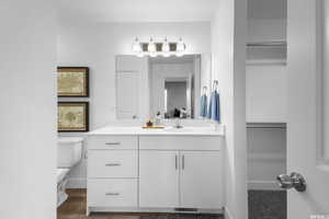 Bathroom with wood-type flooring, toilet, and large vanity *Bathroom includes dual sinks, this photo is a previously built home that did not include the dual sink*