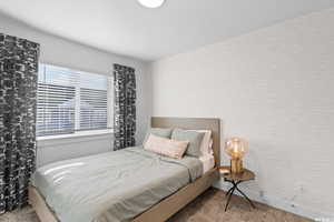 Bedroom featuring light colored carpet