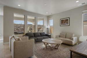 Living room with a healthy amount of sunlight and light tile floors