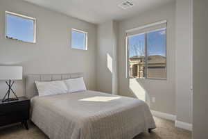 Bedroom with light carpet