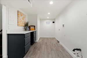 Laundry area featuring washer hookup, light hardwood / wood-style floors, and electric dryer hookup