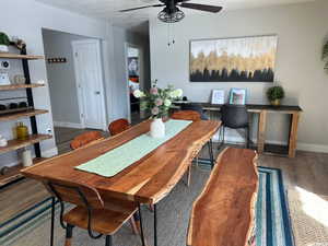 Dining room featuring dark hardwood / wood-style flooring, a textured ceiling, and ceiling fan