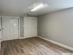 Unfurnished bedroom with a textured ceiling and hardwood / wood-style flooring