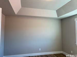 Empty room with dark wood-type flooring